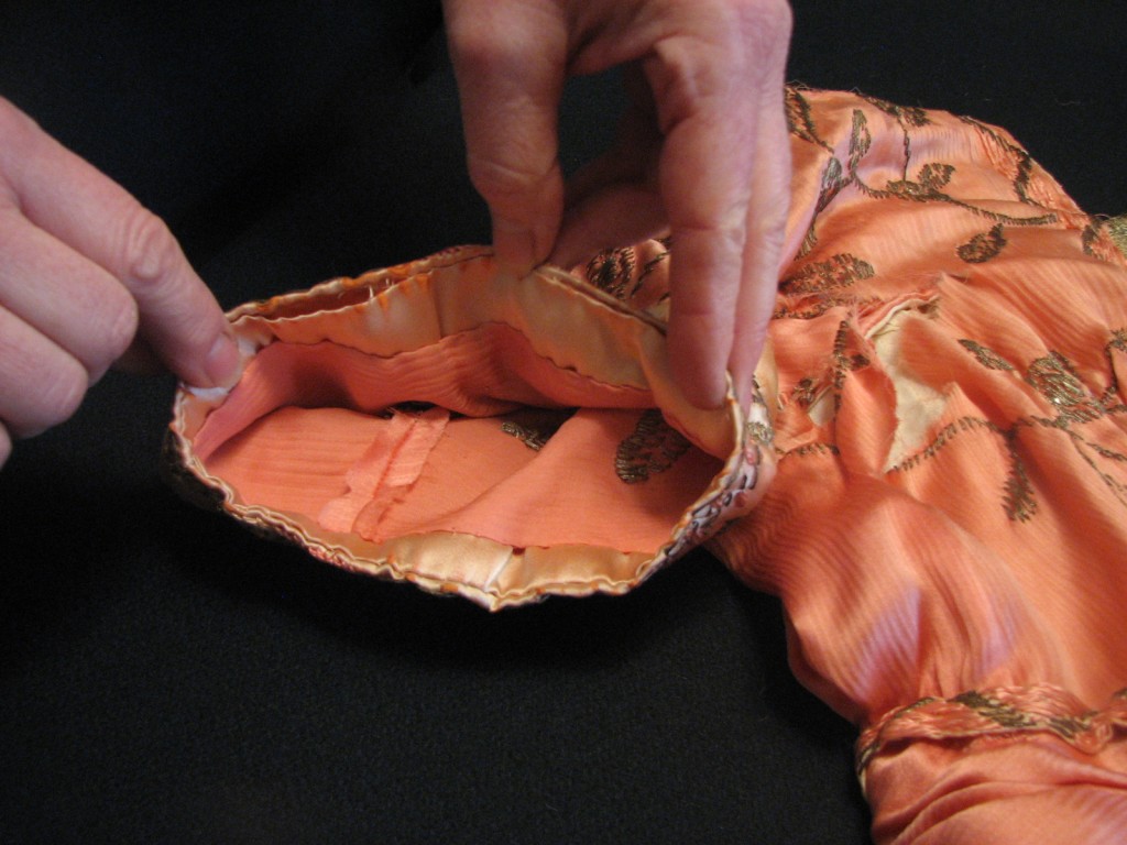 The inside of the sleeve shows the layers of fabric and the method of slip stitching them together.